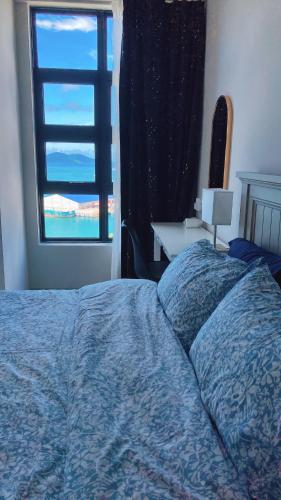a bedroom with a bed with a window and a desk at Mango House3-LuxurySweet I Biggest unit I infinity pool I Wifi-JQ in Kota Kinabalu