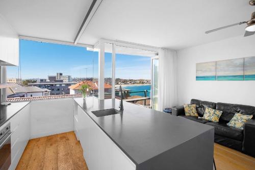 a kitchen and living room with a view of the ocean at S16S - Bondi Vistas in Sydney