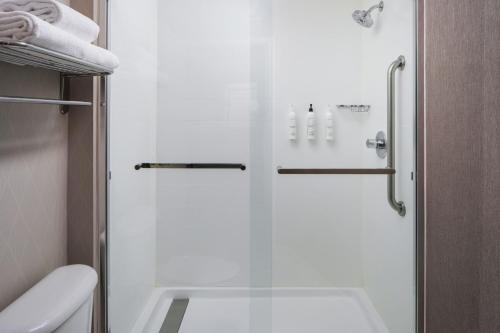 a shower with a glass door in a bathroom at SpringHill Suites Edgewood Aberdeen in Bel Air