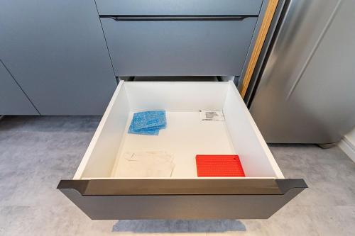 an open drawer in a refrigerator with two items at Housi Brickell One - HBO0105 in Curitiba