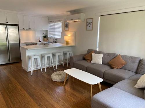 a living room with a couch and a kitchen at Salty in Quindalup