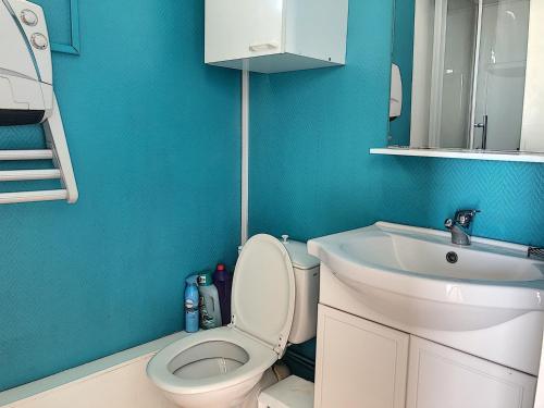 a bathroom with a white toilet and a sink at Appartement avec balcon, jardin, et accès plage - FR-1-361-492 in Jullouville-les-Pins