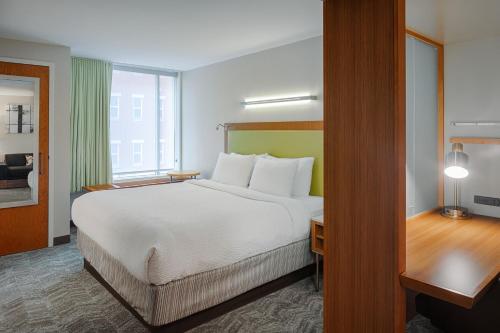 a hotel room with a large bed and a window at SpringHill Suites by Marriott Bloomington in Bloomington