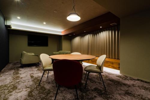 a conference room with a wooden table and chairs at Randor Hotel Hiroshima Prestige in Hiroshima