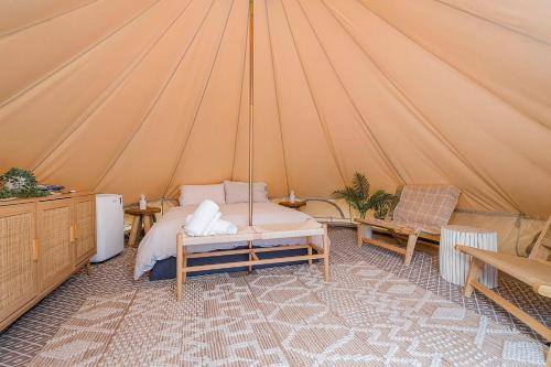 a bedroom with a bed in a tent at Camp Jordan in Port Macquarie