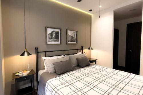 1 dormitorio con 1 cama y 2 luces colgantes en Amerittania 402, en Guadalajara
