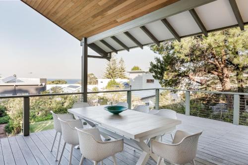a patio with a white table and chairs on a deck at Heavenly Horizons in Dunsborough