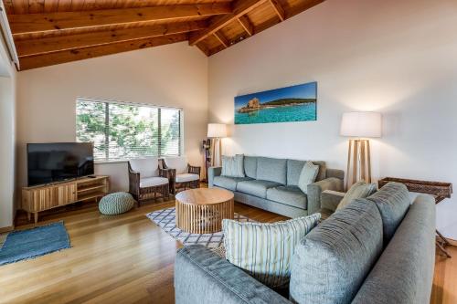 a living room with two couches and a tv at Heavenly Horizons in Dunsborough