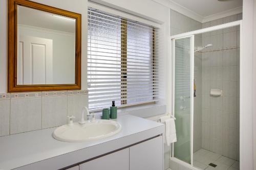 a white bathroom with a sink and a shower at Heavenly Horizons in Dunsborough