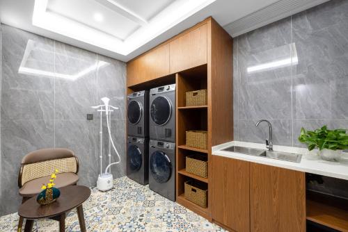 a kitchen with two washing machines and a sink at Nostalgia Hotel S - Beijing National Convention Center in Beijing