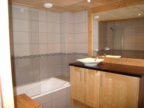 a bathroom with a sink and a bath tub at Appartement Crest-Voland, 5 pièces, 8 personnes - FR-1-733-123 in Crest-Voland