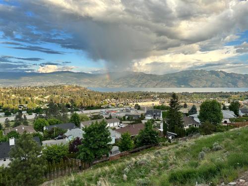 a view of a town with a rainbow in the sky at Shannon Heights B&B in West Kelowna