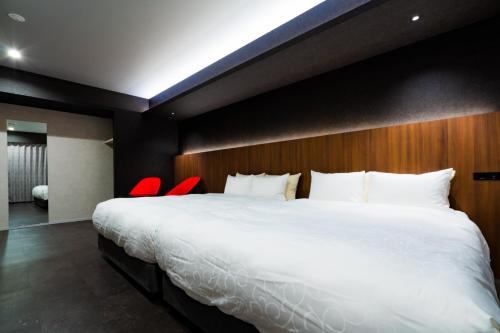 a bedroom with a large bed and red chairs at Randor Hotel Hiroshima Prestige in Hiroshima