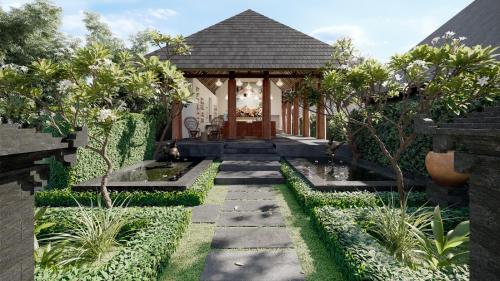 a garden with a pathway and a gazebo at La Reserve 1785 Canggu Beach in Canggu