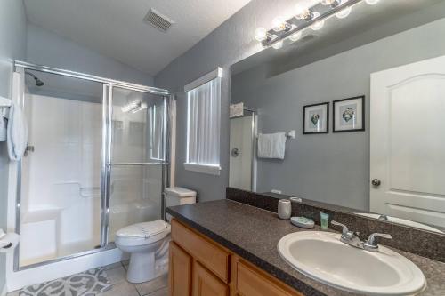 a bathroom with a sink and a shower and a toilet at 17637 Silver Creek in Orlando