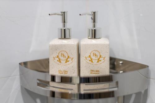 two white soap bottles sitting on top of a table at Bao Hung Hotel & Apartment - Tran Quoc Vuong in Hanoi