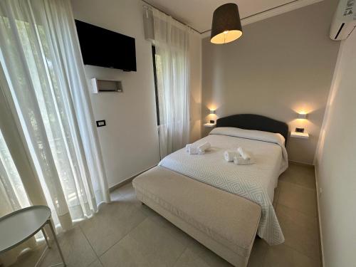 a bedroom with a bed with two towels on it at MIRA taormina rooms in Taormina