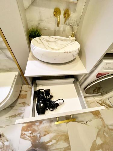a bathroom with a toilet and a sink on a counter at Nida family apartments in Nida