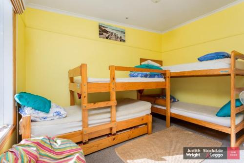 a bedroom with three bunk beds in a room at Heyley Haven in Ventnor