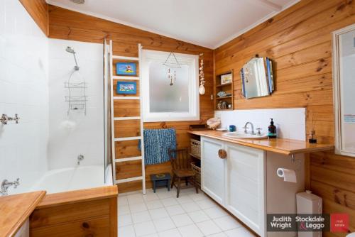 a bathroom with a shower and a sink and a tub at Heyley Haven in Ventnor