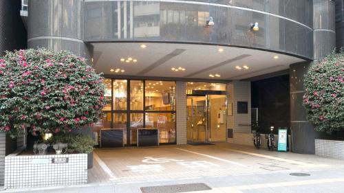 a store front of a building with flowers at Toyoko Inn Tokyo Asakusa Kuramae No 1 in Tokyo