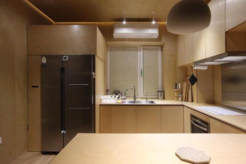 a kitchen with a refrigerator and a sink at Entire apartment or single rooms in Homegarden Park near Camp Humprehys in Pyeongtaek