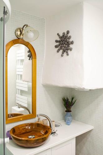 a bathroom with a wooden sink and a mirror at Ubytovanie na dedine in Veľká Chocholná