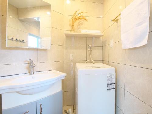 a bathroom with a sink and a toilet and a mirror at Ocean Villa Tin Gala in Onna