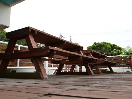 two wooden benches sitting on a wooden deck at Ocean Villa Tin Gala in Onna