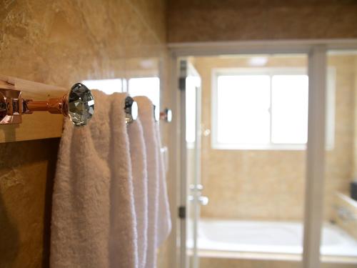 a bathroom with a shower curtain and a window at Ocean Villa Tin Gala in Onna