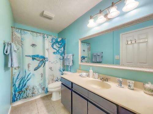 a bathroom with a sink and a toilet and a shower at NEW!! 2BR 4 Beds Condo with Pool in Galveston