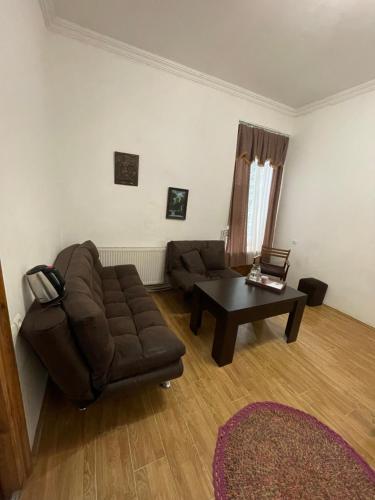 a living room with a couch and a coffee table at Leila Apartment in Tbilisi City