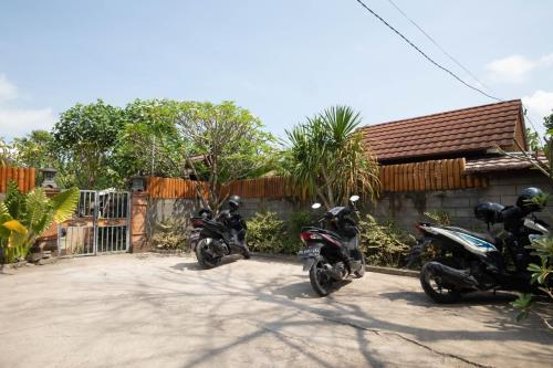 two motorcycles parked in front of a house at Maha Nusa Menjangan in Banyuwedang