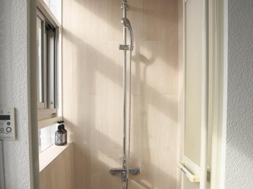a shower with a glass door in a bathroom at Ocean Villa Tin Gala in Onna