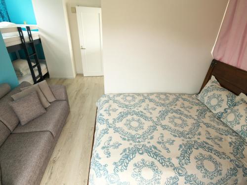 a bedroom with a bed and a couch at Ocean Villa Tin Gala in Onna