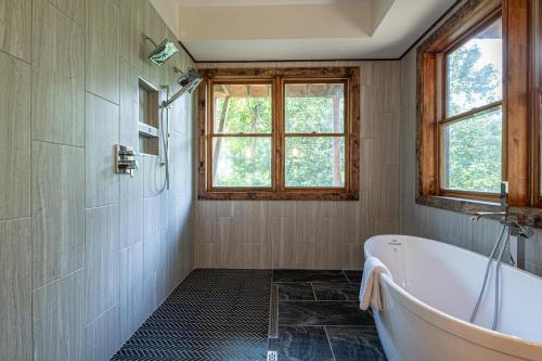 a bathroom with a tub and a window at Hidden Mountain Gem in Gatlinburg
