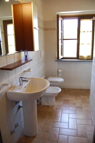 a bathroom with a sink and a toilet at Apartment Il Casino numero 5 in Laiatico
