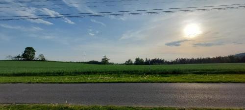 a view of a field from the side of a road at ŠulcBurg in Cetenov