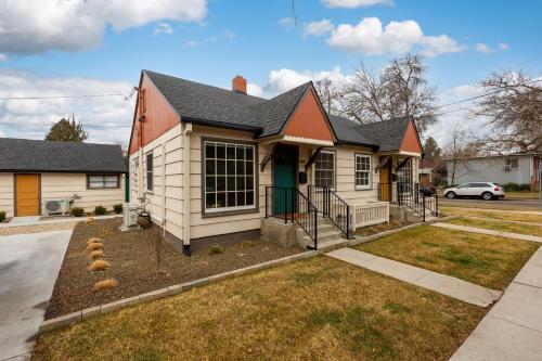 a white house with a red roof at North End Bungalow 1921 in Boise
