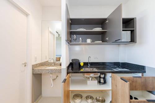 a kitchen with a sink and a counter top at Housi Eco Smart - ECO0407 in Curitiba