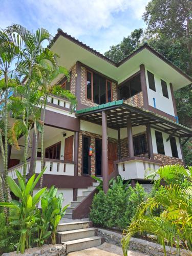 a house with a green and white at Sense Asia in Haad Tian