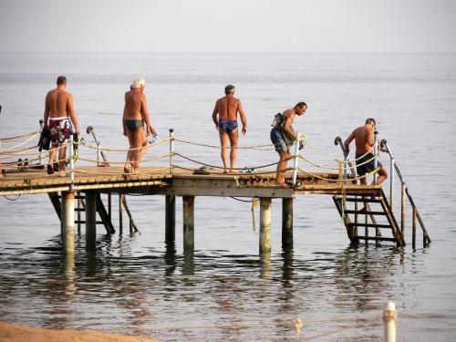 a group of men standing on a pier in the water at Happy Life Village Dahab in Dahab