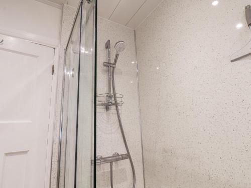 a shower with a shower head in a bathroom at Field Cottage in York