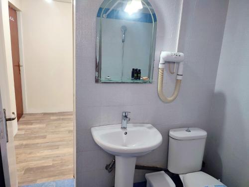 a bathroom with a sink and a toilet and a mirror at ASTY in Mytilene