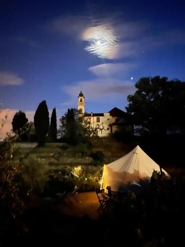 a white tent in front of a building at night at Stecadó Glamping in Dolceacqua