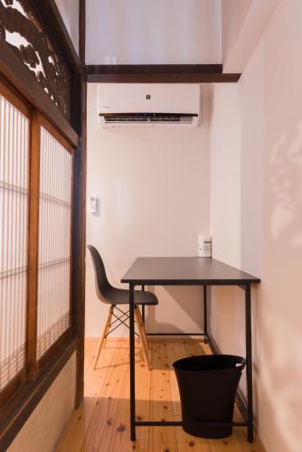 a black table in a room with a chair at FARMSTAY miyuki-street "Goen" in Ukiha