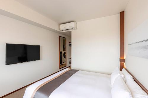 Кровать или кровати в номере Tokyu Stay Fukuoka Tenjin