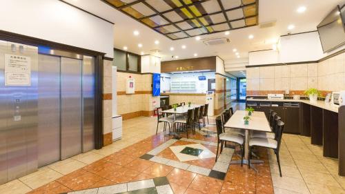 a restaurant with tables and chairs in a room at Toyoko Inn Tokyo Kamata Higashi-guchi in Tokyo