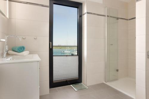 a bathroom with a shower and a glass door at Stressless in Heiligenhafen