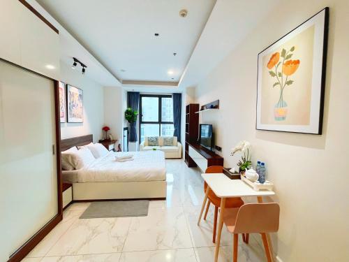 a bedroom with a bed and a table and a desk at De Lux Central Studio next Hyatt ,Opera House ,Benthanh ,Pool,Gym in Ho Chi Minh City